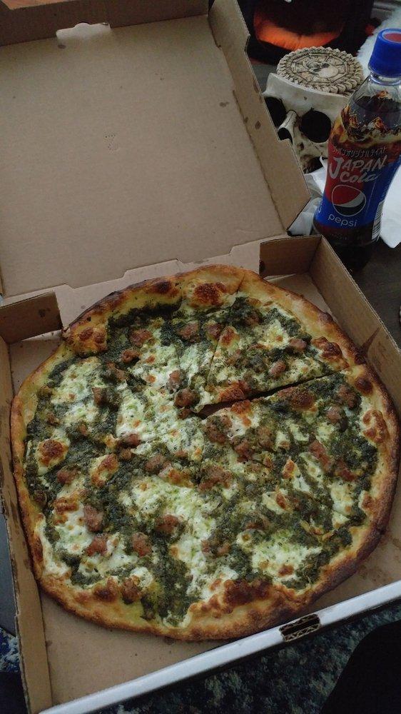 Pesto Pizza · Hand sliced mozzarella and basil pesto sauce drizzle. Topped with our signature cheese and spice blend. Nut free.