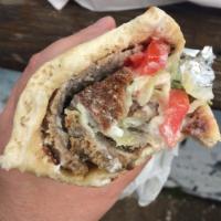 Lamb Gyro Wrap · A delicious mixture of lamb and beef wrapped in a fluffy pita with lettuce, tomatoes, onions...