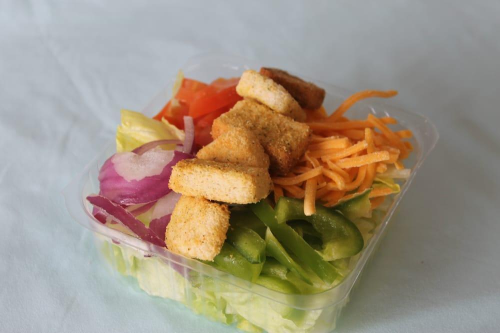Garden Salad · Fresh cut Iceberg lettuce with tomatoes, red onions, green peppers, cheddar cheese and choice of dressing.