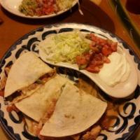 Quesadilla · Grilled tortilla filled with cheese. Served with lettuce, sour cream, and pico de gallo.