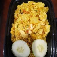 Pineapple Fried Rice · Stir-fried jasmine white rice with yellow curry powder, cashew nut, raisin, egg, onion and p...
