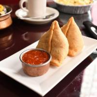 Meat Samosa · Cooked ground chicken, green peas, ginger garlic paste and lots of Indian species stretch in...