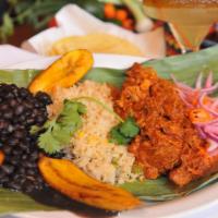 Cochinita Pibil · A traditional dish from the Yucatan Peninsula, slow-roasted pork marinated in an achiote-cit...