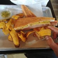 Sandwich Cubano · Sweet ham, roasted pork, Swiss cheese, pickles, mustard on grilled Cuban bread.