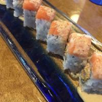 Orange Blossom Roll · Shrimp tempura, spicy crab topped with salmon and tangy sauce.