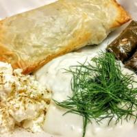 Spanakopita · Fillo dough filled with spinach and cheese, housemade tzatziki sauce.