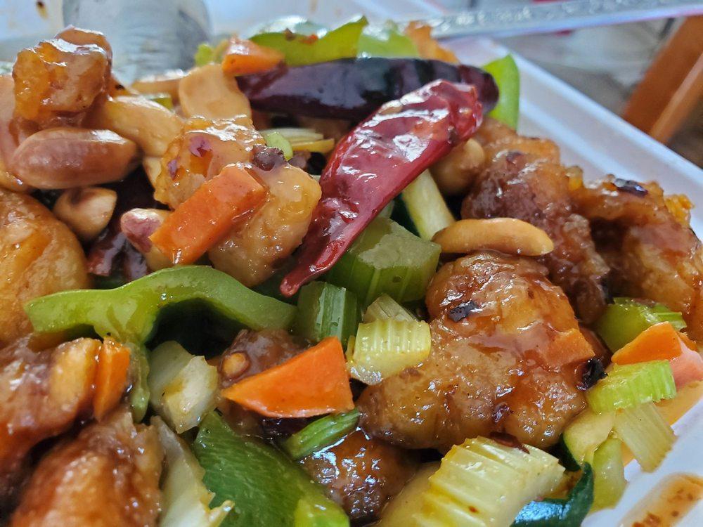 C5 - Kung Pao Chicken · Battered chicken, celery, carrots, bell peppers, long red peppers, squash, in a savory and spicy sauce. Served with peanuts on top. Served with a side of rice. Spicy.