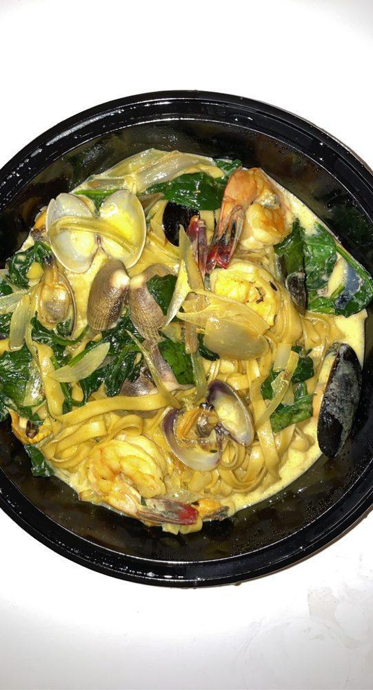 Seafood Pasta · Tagliatelle in a saffron broth with shrimp, mussels, clams and spinach. 
