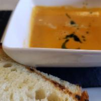 Roasted Red Pepper Crab Bisque · Basil oil and golden sherry drizzle.
