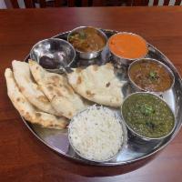 Non Vegetable Thali · A plate with 7 small pots, curry, lamb curry, vegetables, rice, raia, deesert and naan or ch...