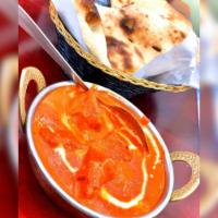 Butter Chicken · Tandoori chicken (dark meat) cooked in a tomato sauce seasoned with fenugreek leaves.