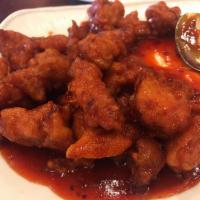 Orange Chicken · Battered chicken sauteed with orange peels in a sweet and spicy sauce. Spicy.