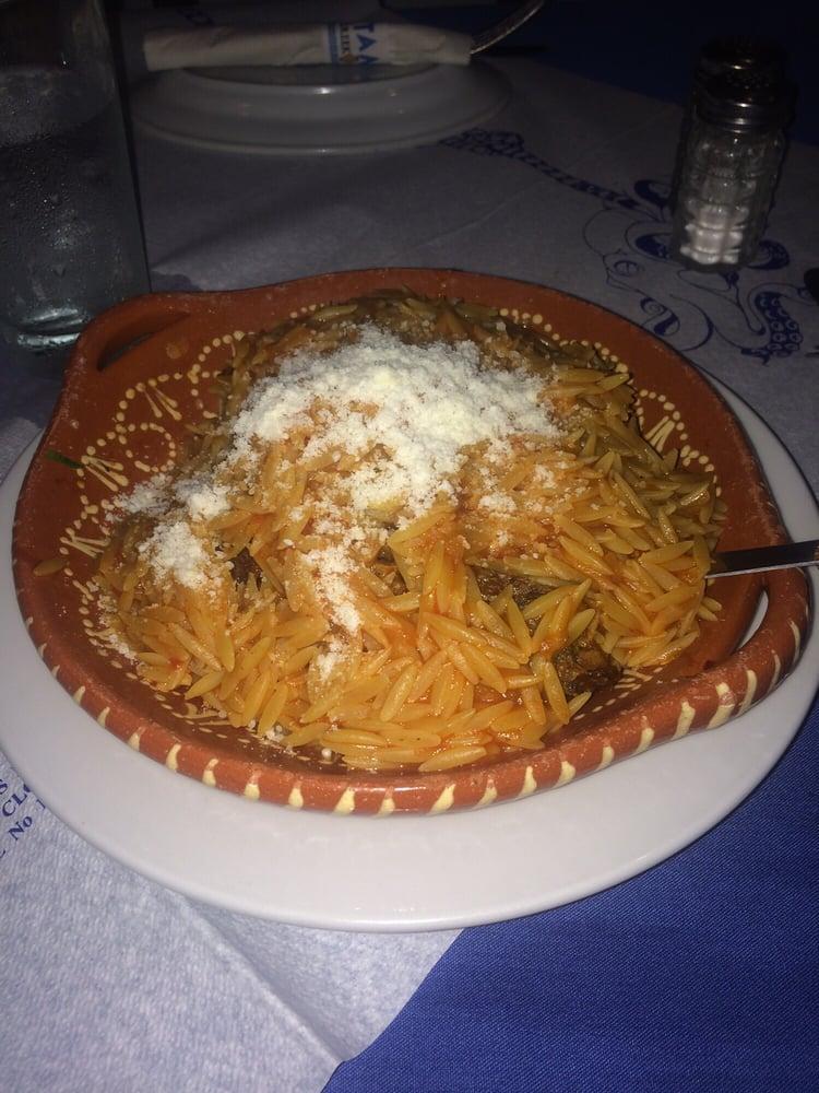 Arni Kokkinisto · Lamb braised in savory tomato sauce with orzo, sprinkled with Parmesan cheese.