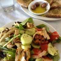 Seafood Salad · Octopus, calamari and shrimp with arugula, tomatoes, cucumbers, onions, lemon and olive oil.