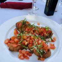 Bruschetta · Toasted ciabatta bread topped with fresh chopped tomatoes, basil and garlic.