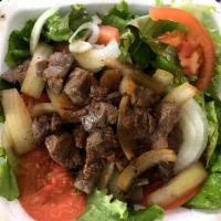 Com Bo Luc Lac · Cubed beef with stir-fried onions.