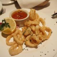 Fried Calamari · Rings of squid battered and fried, served with marinara sauce and lemon.