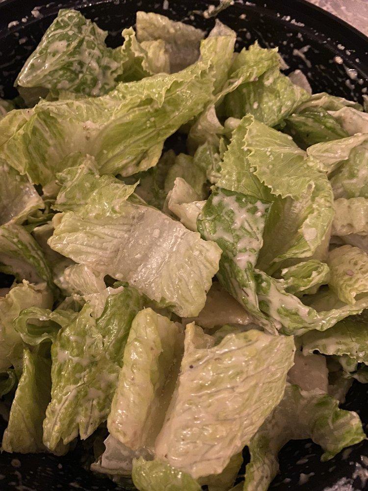 Caesar Salad · Romaine lettuce cut in inch and baked croutons tossed with grated Parmesan cheese and homemade Caesar dressing. Topped with shaved parmesan cheese.