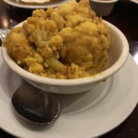 Aloo Gobi · Cauliflower and potatoes, sauteed with fresh tomatoes, ginger, green chili and ground corian...