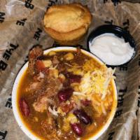 Brisket Chili · Slow Simmered Chopped Brisket and Bean Chili served with Sour Cream, Green Onion, and Cornbr...