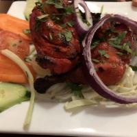 Tandoori Chicken · Tandoor fried chicken on the bone with mild spices. Marinated meats and vegetables cooked in...