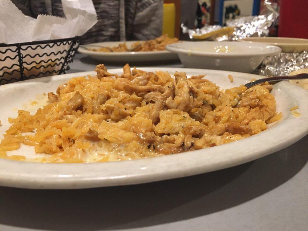 Arroz Con Pollo · Cooked Mexican rice with grilled chicken covered with white queso sauce and served with soft warm tortillas.