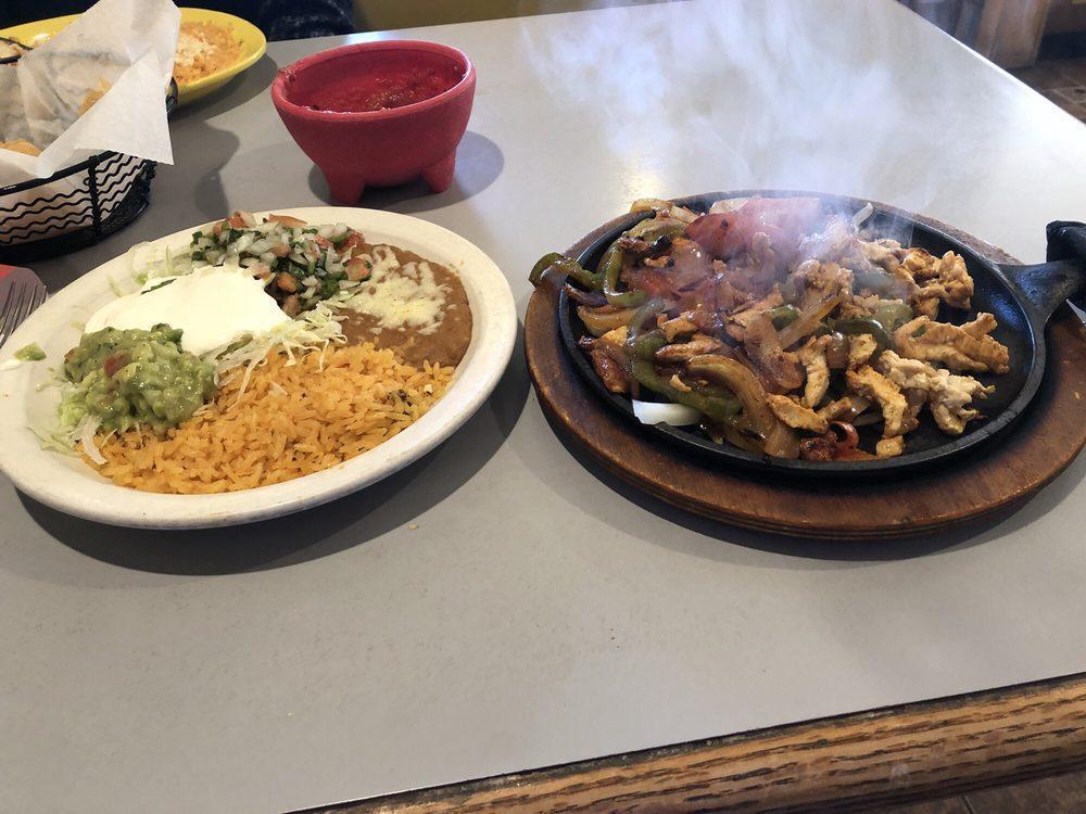 Chicken Fajitas · Tender slices of chicken cooked with onions, tomatoes, and peppers. Side salad and side of rice and beans.