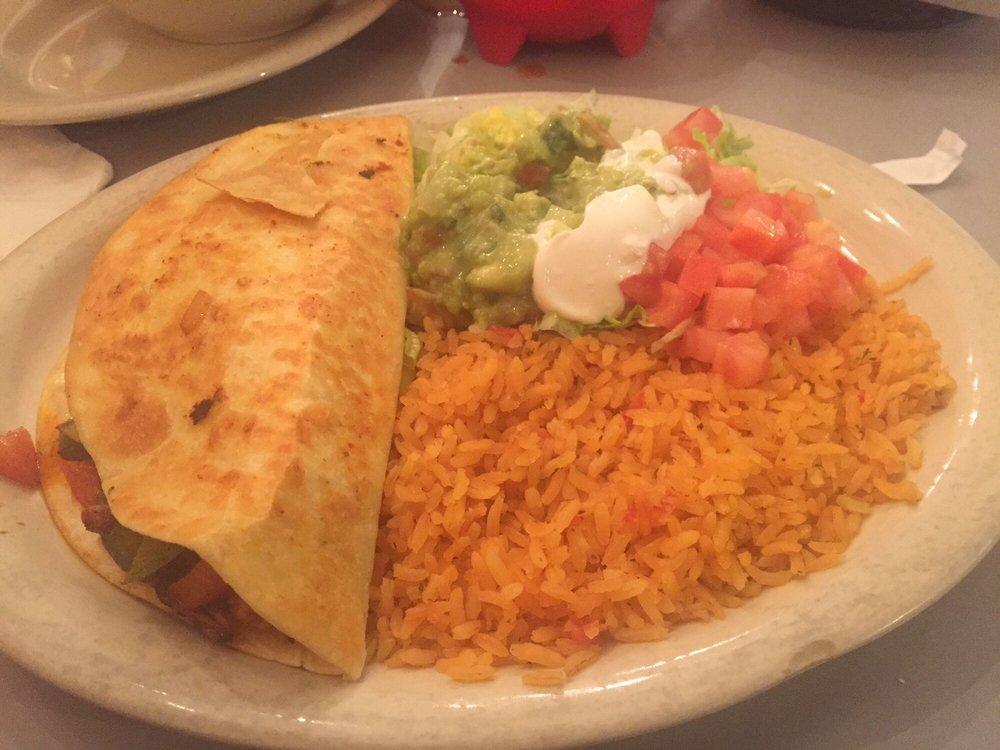 Fajita Quesadilla · Delicious quesadilla choice of grilled chicken, grilled steak, or shrimp cooked with onions, tomato, peppers, and side salad. Lettuce, guacamole, and sour cream. Served with a side of rice.
