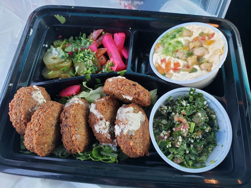 Falafel Plate · Preferences: Vegan, vegetarian.
Ingredients: 6 falafel pieces, hummus, tabbouleh, tahini sauce, greens, turnip pickles & Pita-Bread.
