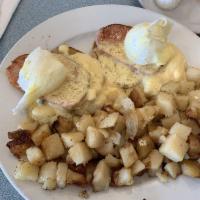 Eggs Benedict · An English muffin topped with Canadian bacon, 2 poached eggs and Hollandaise sauce. Served w...