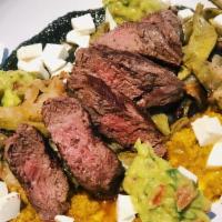 Mula Steak · Grilled hanger steak covered in mole sauce along with zucchini, sweet plantains and topped w...