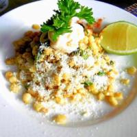 Esquites · Roasted corn salad with epazote, topped chili powder, mayonnaise and sprinkled with Cotija c...