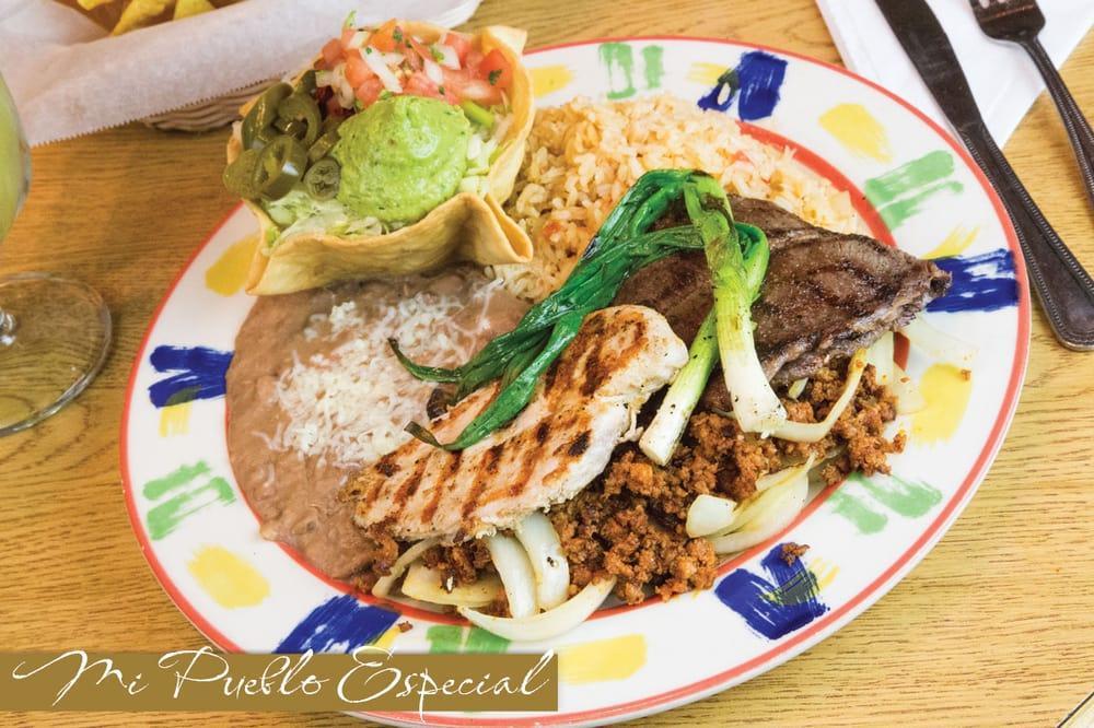 Mi Pueblo Especial · 4 oz. grilled chicken breast, 4 oz. flank steak set on a mix of chorizo (Mexican Sausage) and grilled onions. Served with Mexican rice, refried beans, guacamole salad, pico de gallo and jalapeno peppers.