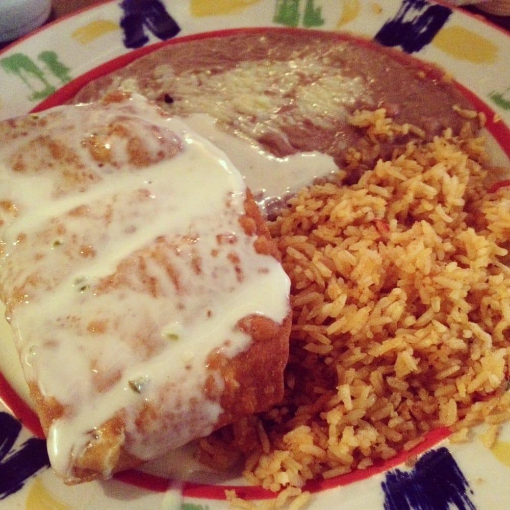 Chimichanga · Chunks of beef or chicken wrapped in a fried flour tortilla and topped with cheese sauce. Served with Mexican rice and a choice of refried beans or guacamole salad.