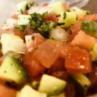 Persian Salad · Freshly chopped and diced tomatoes, cucumbers and onions with lemon juice and parsley.