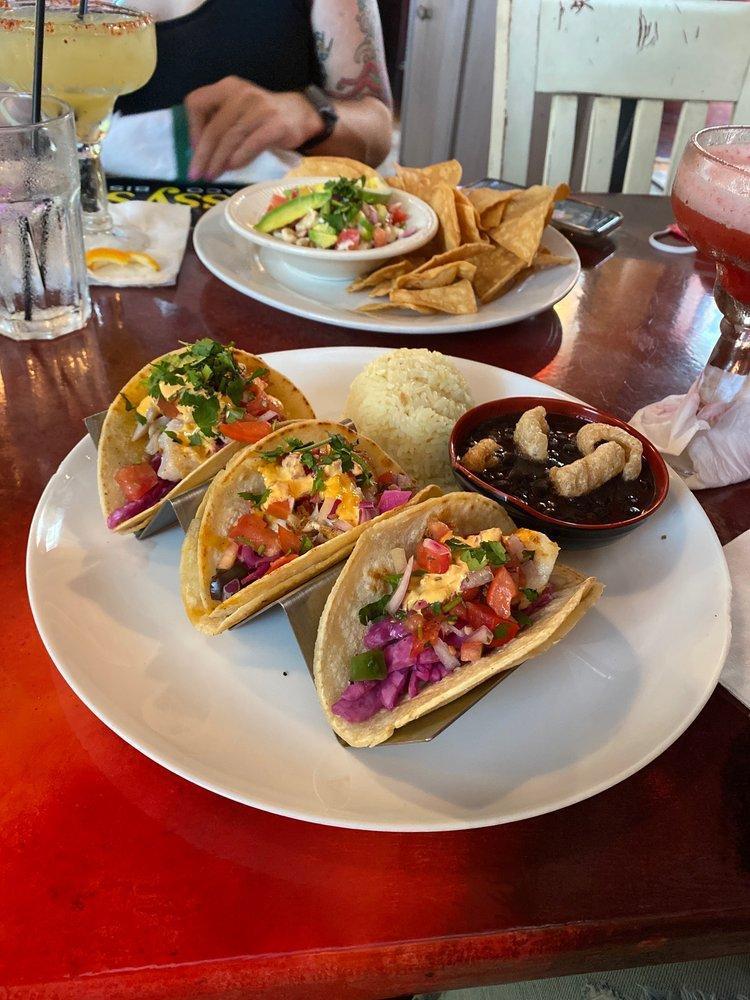 Grilled Fish Tacos · Three Rockfish Grilled Tacos, served on corn tortillas with our oregano lime slaw, pico de gallo and spicy ioli.