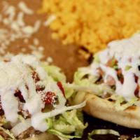 Sopes · 2 hand made thick corn dough sopes topped with your choice of meat, beans pico, Cotija chees...