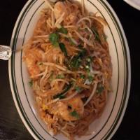 Pad Thai · Sauteed rice noodles with egg, ground peanuts, dried bean curd, bean sprouts, and scallions....