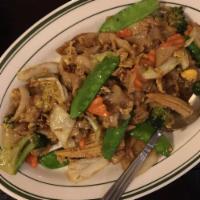 Pad See Ew · Your choice of beef, chicken, or pork sauteed with fresh broad noodles, Thai brown sauce, eg...