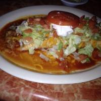 Macho Burrito · The most popular burrito filled with rice and beans and choice of chicken, ground beef or pi...