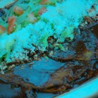 Enmoladas · This enchiladas but a twist made with mole sauce and chicken.