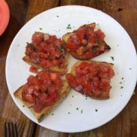Bruschetta · Fresh Roma tomatoes, Parmesan, garlic, basil, olive oil, homemade rustic crostini.