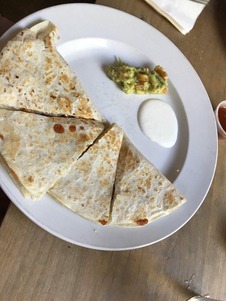 Quesadilla · Flour tortilla stuffed with cheese, mushrooms, poblano pepper, caramelized onions, topped with guacamole and sour cream.