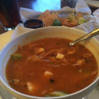Tortilla Soup · Made with roasted tomatoes, chicken broth and pasilla chile. Topped with diced avocado, ques...