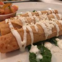 Taquitos · 3 crispy rolled corn tortillas, filled with chicken, topped with lettuce, sour cream and pic...
