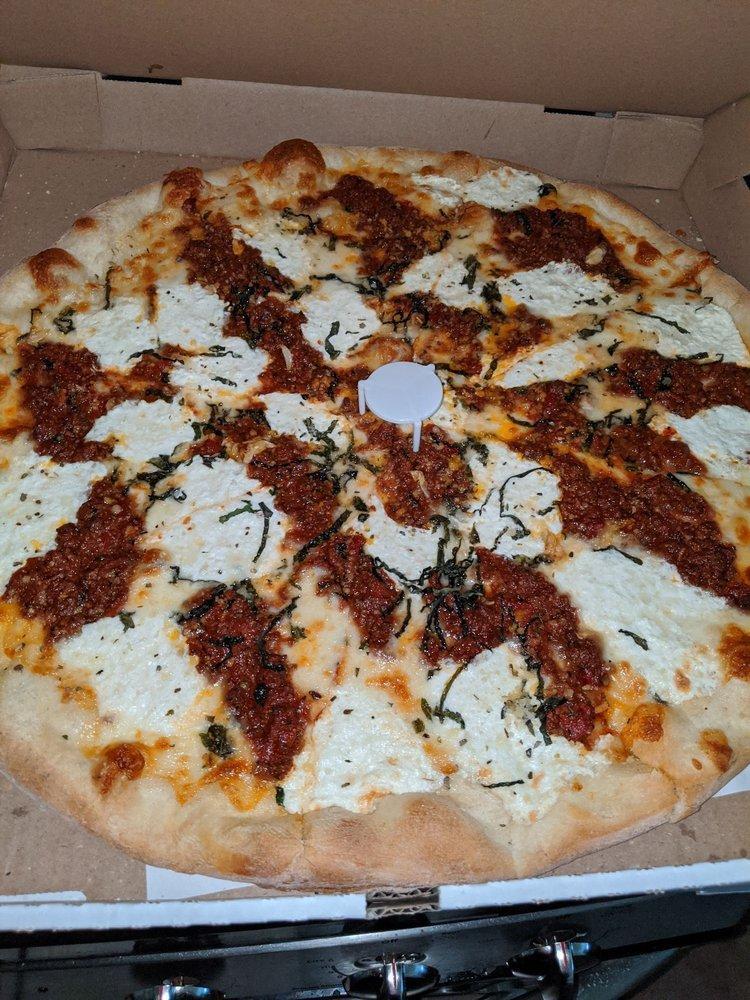 Lasagna Pizza · Fresh ground beef, fresh garlic, mozzarella, Parmesan and ricotta cheese with homemade marinara sauce.
