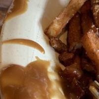 Poutine · Pooh-tin, Quebec. From the backwoods of Quebec, Canada, white cheddar cheese curds over hand...
