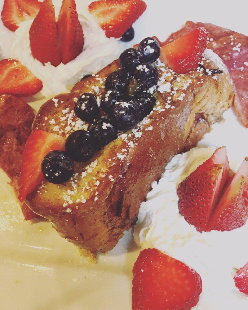 Stuffed French Toast · 2 slices of challah French toast ( secret recipe batter) topped with whip cream, seasonal fruit and candied walnuts. 