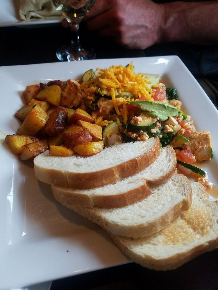 Tofu Scramble · Firm tofu, mushrooms, red onions, zucchini, tomatoes, spinach and topped with avocado. Add soy cheese for an additional charge. Vegan.