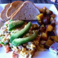 Cowboy Scramble · Ham, green peppers, red onion, tomato, Tillamook cheddar and topped with avocado.